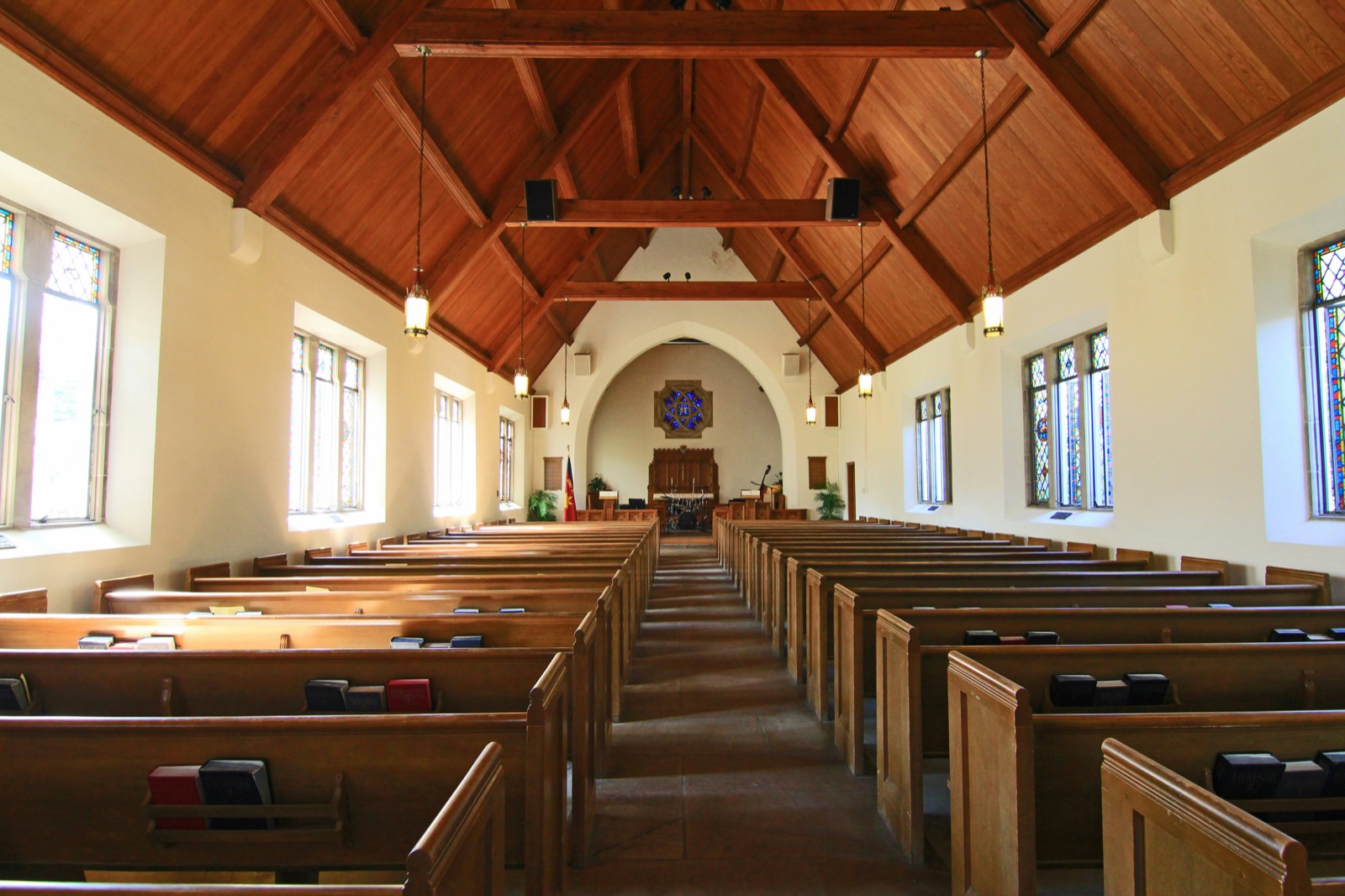Church sanctuary with pews beneath an open timber ceiling