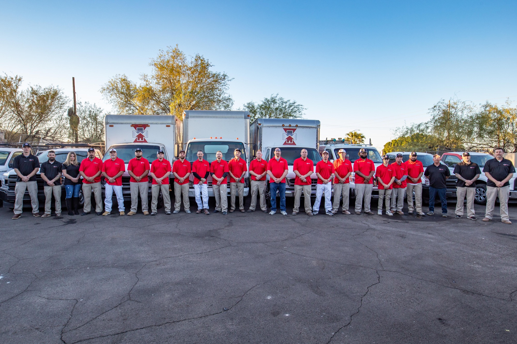 National First Response restoration team standing with company fleet vehicles