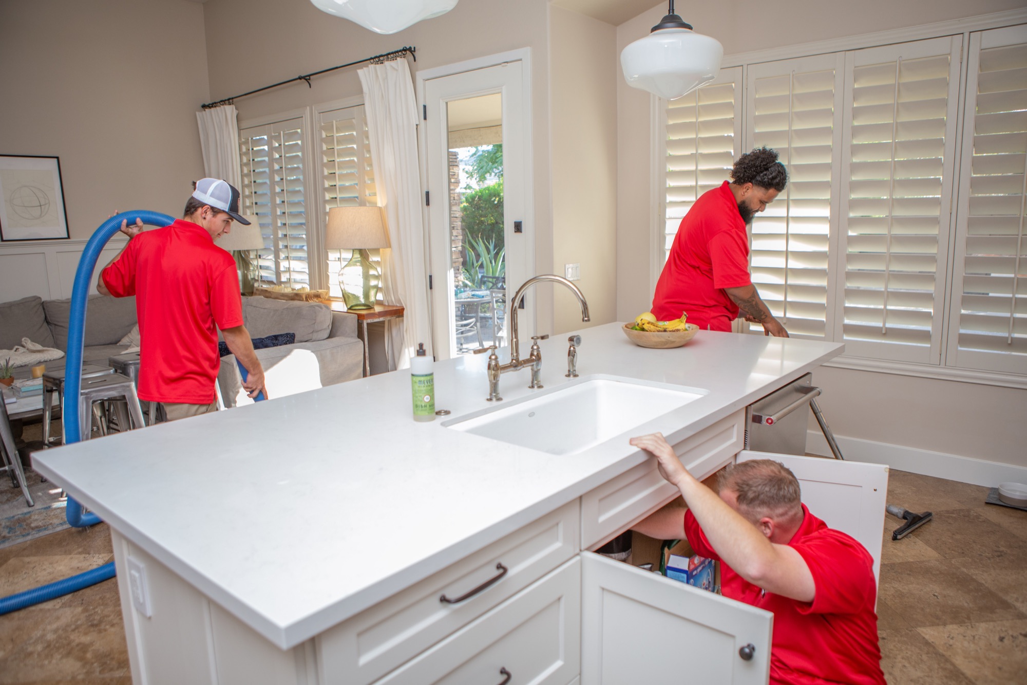 Technicians mitigating damage inside a home