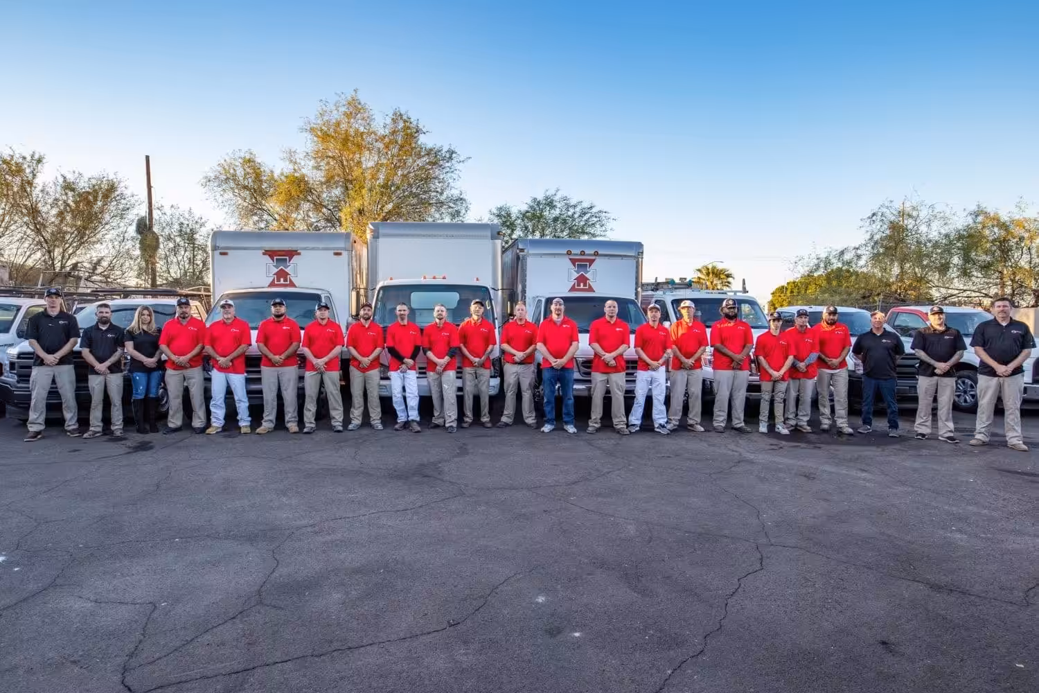 National First Response field and office team together beside company vehicles