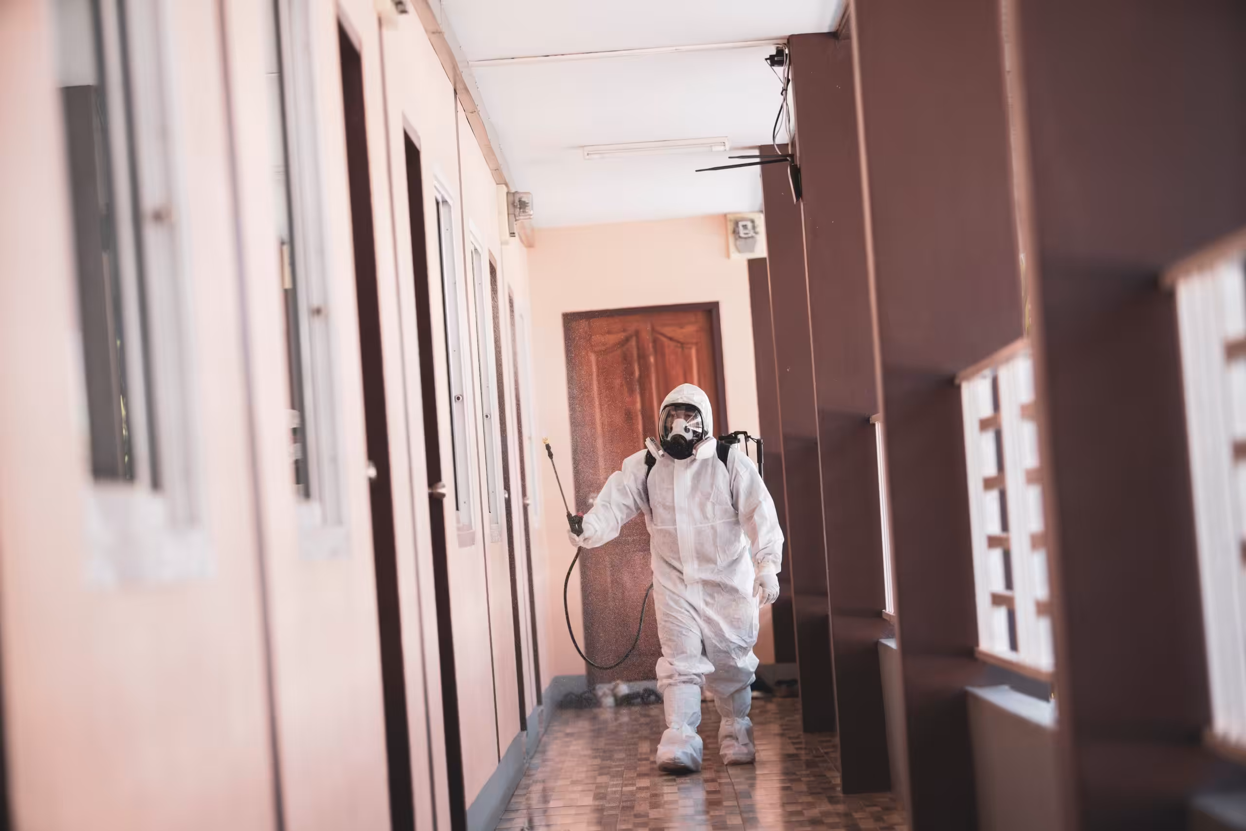 Technician treating smoke odor in a hallway