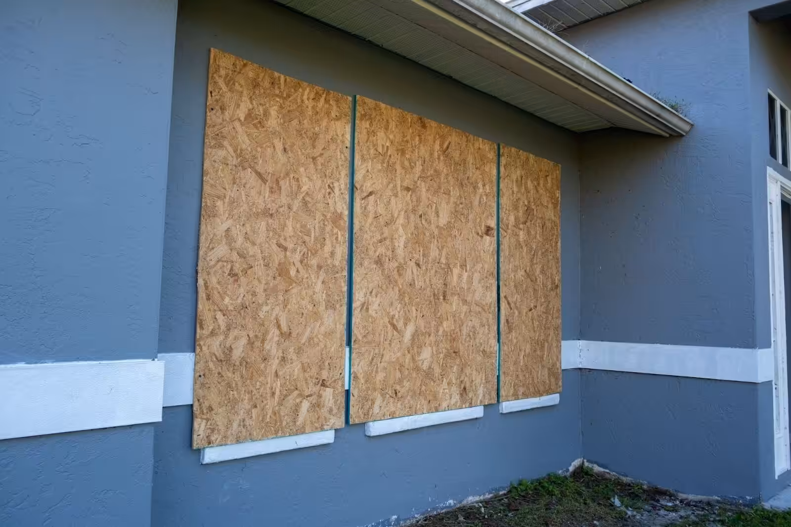 Board up services securing a home with plywood after property damage